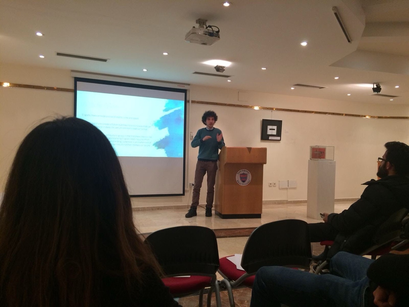 Mert presenting to a seated audience